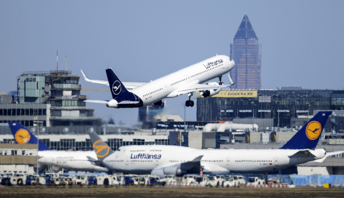 A Lufthansa Airbus takes off at Frankfurt Airport above other passenger aircraft of the airline, Germany, Monday, March 23, 2020.