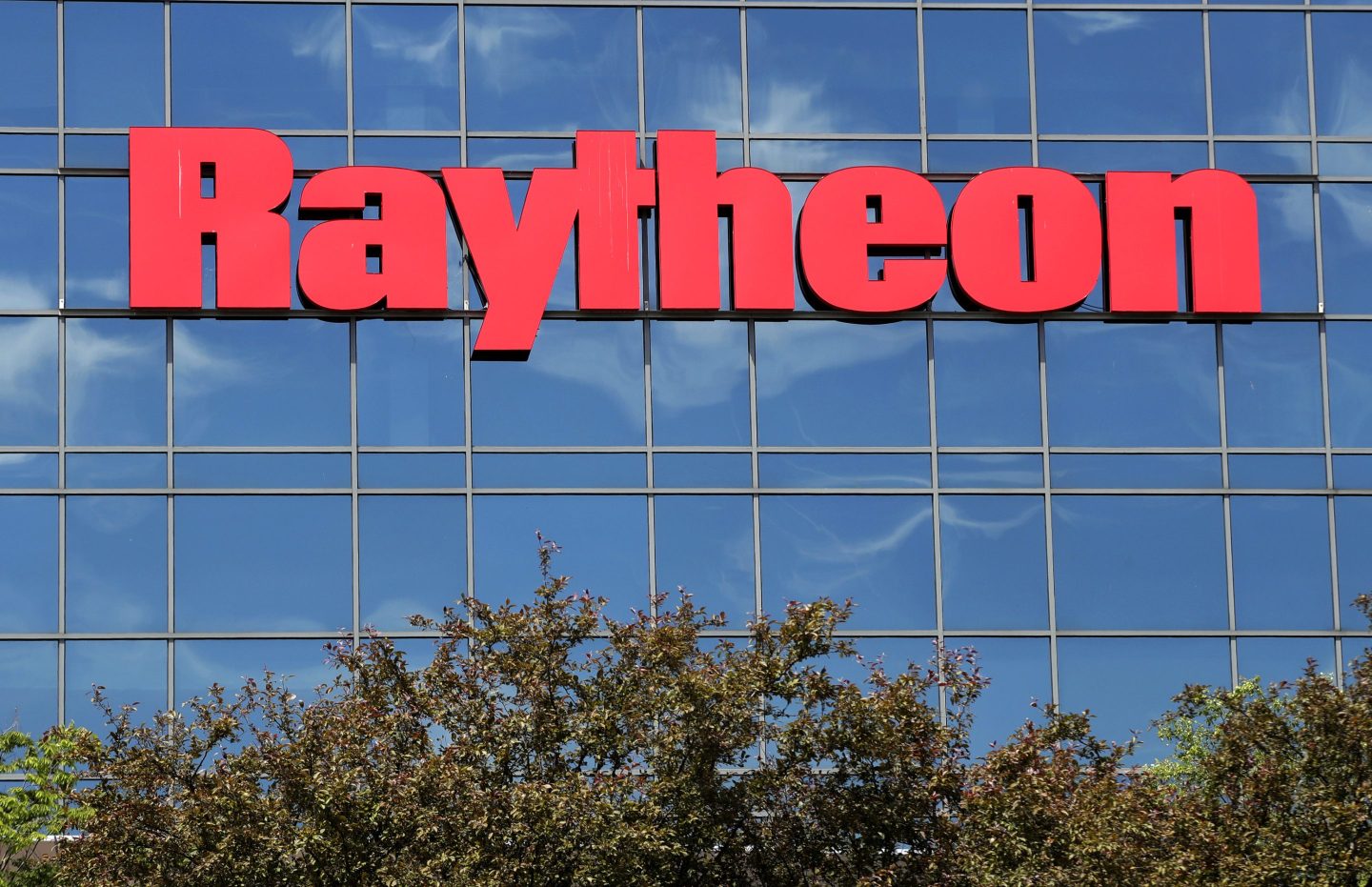 he sky is reflected on the facade of Raytheon's Integrated Defense Systems facility.