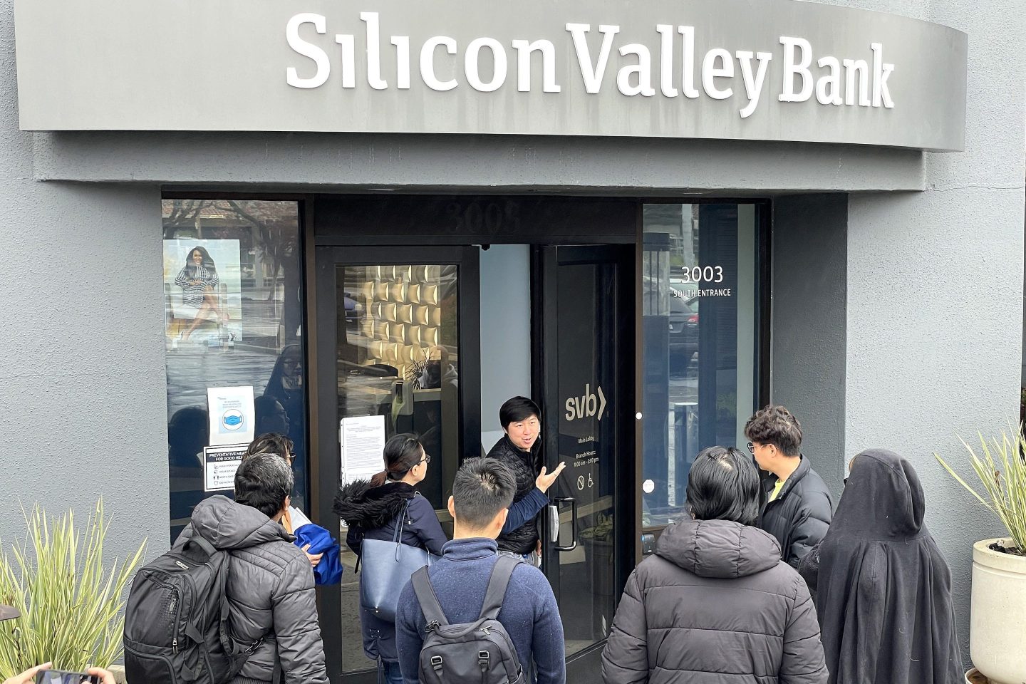 SANTA CLARA, CALIFORNIA &#8211; MARCH 10: A worker (C) tells people that the Silicon Valley Bank (SVB) headquarters is closed on March 10, 2023 in Santa Clara, California. Silicon Valley Bank was shut down on Friday morning by California regulators and was put in control of the U.S. Federal Deposit Insurance Corporation. Prior to being shut down by regulators, shares of SVB were halted Friday morning after falling more than 60% in premarket trading following a 60% declined on Thursday when the bank sold off a portfolio of US Treasuries and $1.75 billion in shares to cover  declining customer deposits. (Photo by Justin Sullivan/Getty Images)