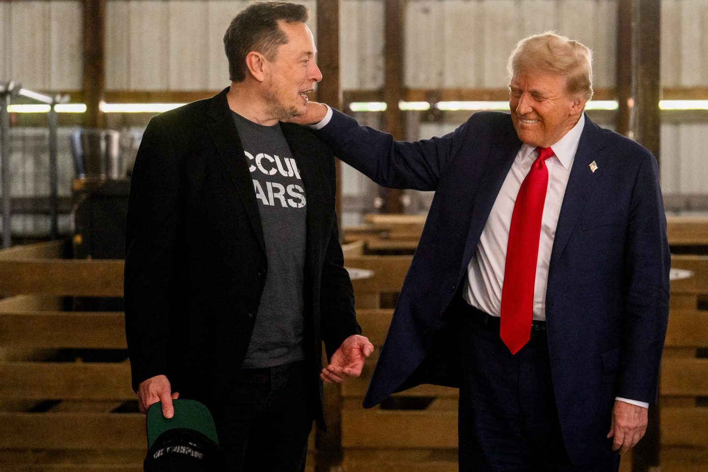 Elon Musk, chief executive officer of Tesla Inc., left, and former US President Donald Trump, prior to a campaign event at the Butler Farm Show in Butler, Pennsylvania, US, on Saturday, Oct. 5, 2024. Republican nominee Donald Trump rallied supporters at the site of a July assassination attempt, returning to the Pennsylvania venue where a gunman&#8217;s bullet bloodied his ear and upended the presidential campaign. Photographer: Justin Merriman/Bloomberg via Getty Images