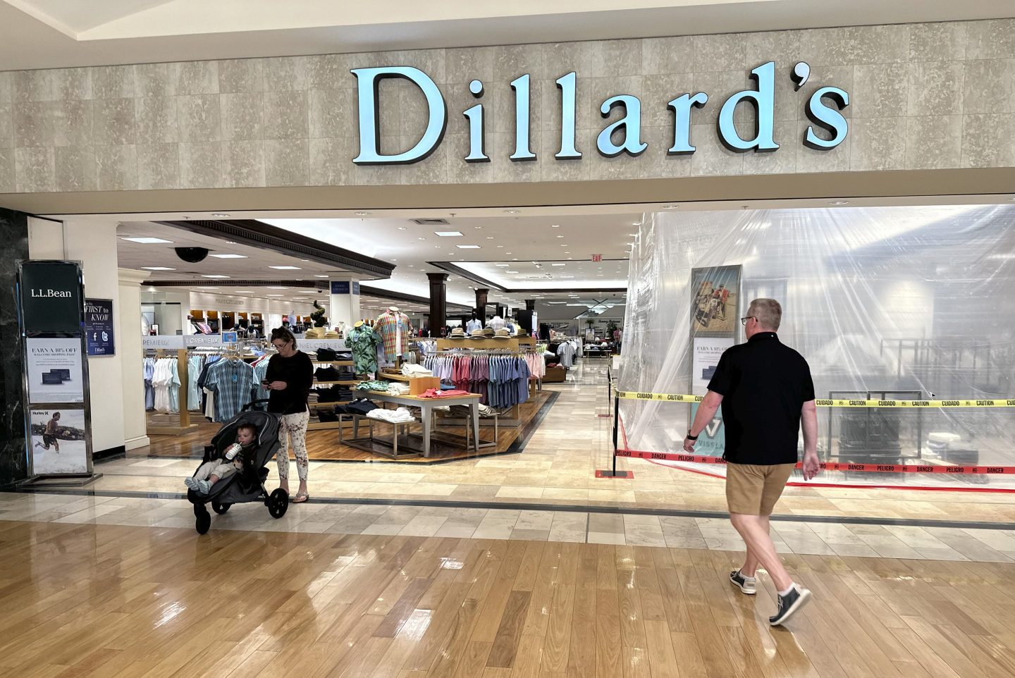 Shoppers filter into a Dillard's department store in a mall Monday, April 29, 2024, in Lone Tree, Colo