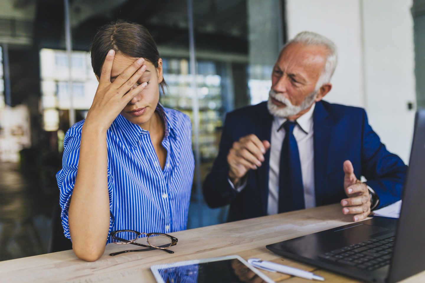 Worker is frustrated during performance evaluation with her boss.