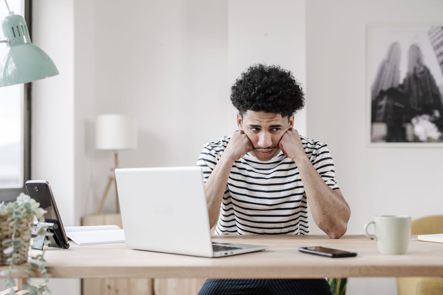 Young man at computer looking frustrated