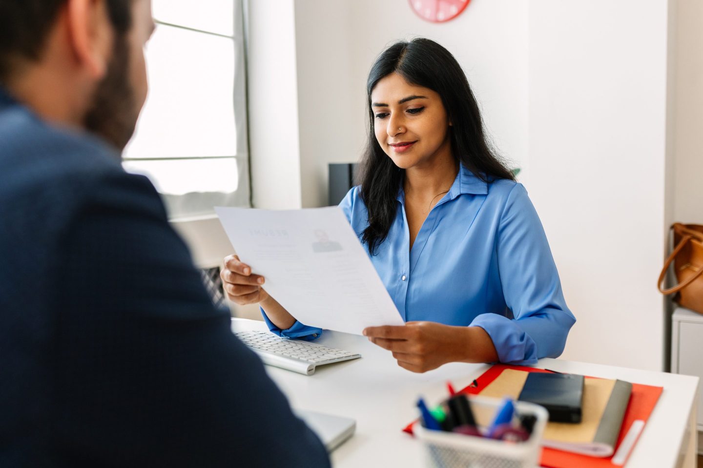 Female recruiter looks at a résumé