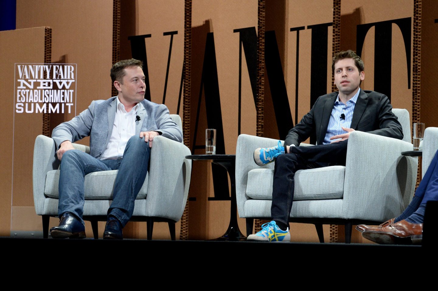 Elon Musk and Sam Altman sitting in chairs