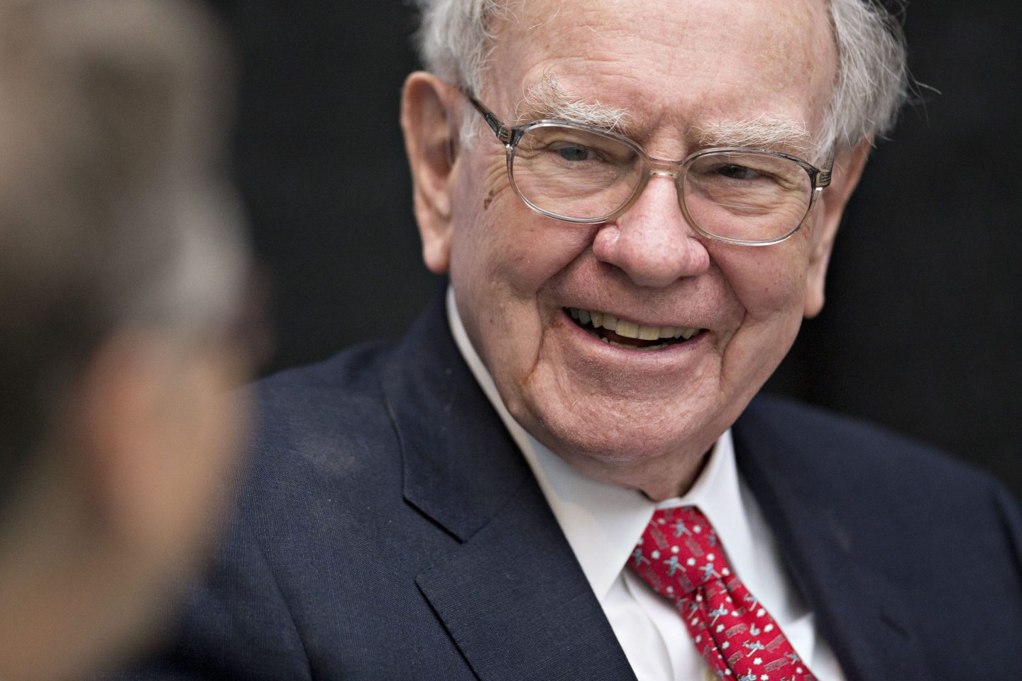 Warren Buffett, chairman and chief executive officer of Berkshire Hathaway Inc., laughs while playing cards on the sidelines the Berkshire Hathaway annual shareholders meeting in Omaha, Nebraska, U.S., on Sunday, May 1, 2016. Dozens of Berkshire Hathaway subsidiaries will be showing off their products as Chief Executive Officer Warren Buffett hosts the company's annual meeting. Photographer: Daniel Acker/Bloomberg via Getty Images