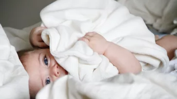 a baby lying on a bed