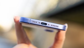 Close-up of an iPhone 16 showing the bottom with a USB-C port and speaker holes.