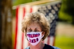 FILE - A supporter wears a face mask ahead of President Donald Trump's visit to an Owens and Minor warehouse in Allentown, Pennsylvania, May 14, 2020.