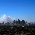 The city skyline is seen as the Palisades Fire burns amid a powerful windstorm on January 7, 2025 in Pacific Palisades, California.