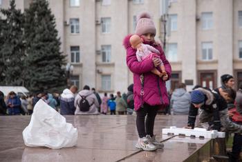 A girl holds her doll in the central square in Kherson, Ukraine (file).