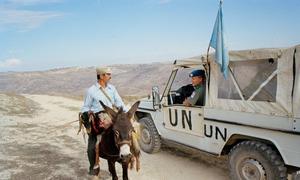 A UNIFIL peacekeeper talk to a local man in the hills of southern Lebanon.