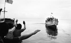 Vietnamese refugees (foreground) bid farewell to other refugees who are leaving for Malaysia.