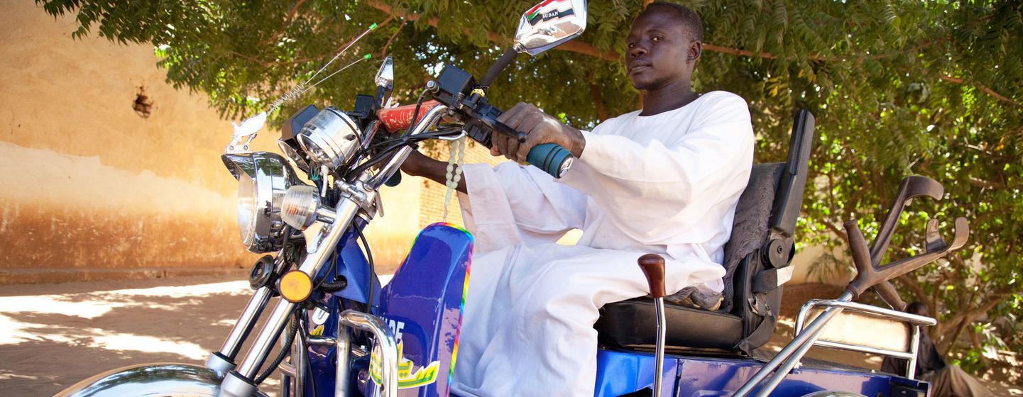 Sheij Aldine, a member of the Sudanese Association for Disabled People, rides a special motorbike provided by the organization in North Darfur, Sudan. (file)