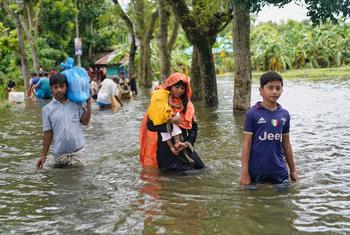 People wading through flood waters in search of shelter in Feni following catastrophic flooding that displaced five million people in southeastern Bangladesh in August 2024. (file)