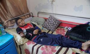 A 13-year-old boy recovers at Nasser Hospital in Khan Younis, Gaza Strip after his crushed and gangrenous lower arm was amputated.