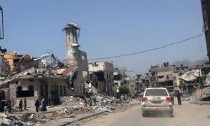 A UN vehicle passes through the ruins of Gaza City.