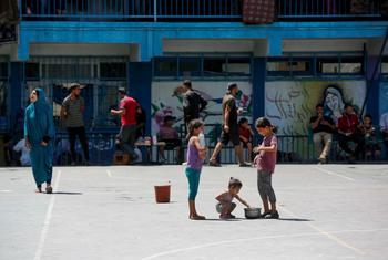 Children in Gaza play in a school converted into a shelter for families displaced by the conflict.