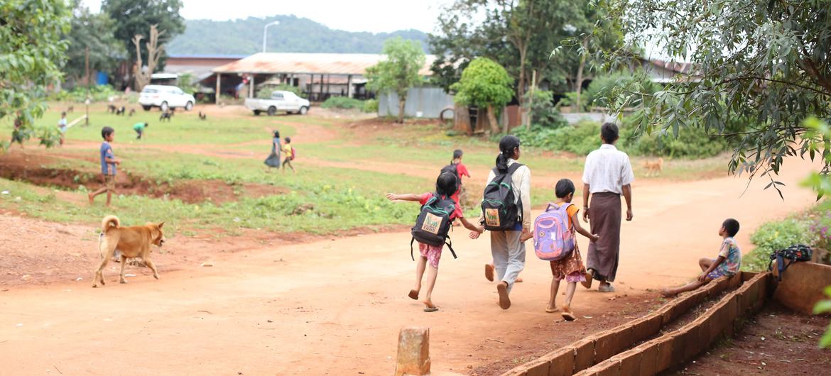 Children return home after classes at a migrant learning centre.