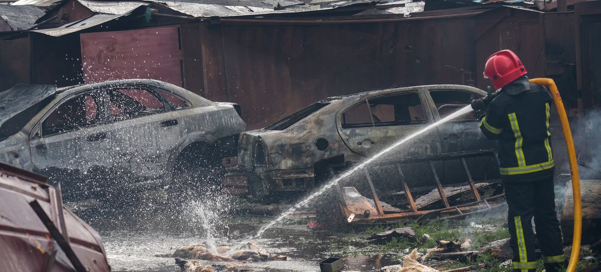 In Poltava, a city in central Ukraine, emergency service personnel work to douse debris left smoldering after an attack.