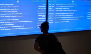 A delegate checks the daily schedule of official meetings at UNGA78.