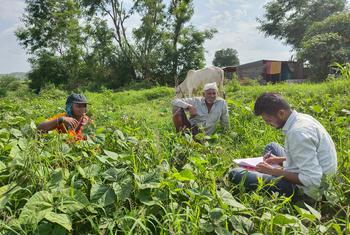 Siddhesh Sakore (right) works with farmers in Pune, India.