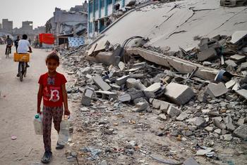 A young girl collects water in the Gaza Strip.