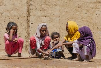 Children collect clean water from a pipe connected to their household.