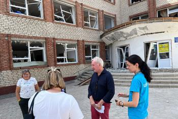 Humanitarian Coordinator for Ukraine Matthias Schmale (2nd from right) stands in front of a transit centre for displaced people fleeing hostilities in the front-line Donetsk Region.