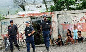 An elite police intervention unit trained by Portuguese officers patrols a neighbourhood of Dili following reports of fighting between two rival gangs.