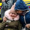 Families arrive in Berdyszcze, Poland, after crossing the border from Ukraine, fleeing escalating conflict.