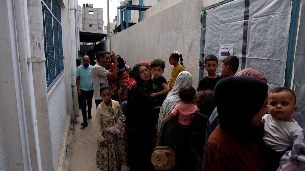 Des familles font la queue dans une clinique de l'UNRWA dans le camp d'Al-Nuseirat, à Gaza, attendant que leurs enfants se fassent vacciner contre la polio.