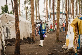 A community health worker walks through an IDP camp in North Kivu in eastern Democratic Republic of the Congo.