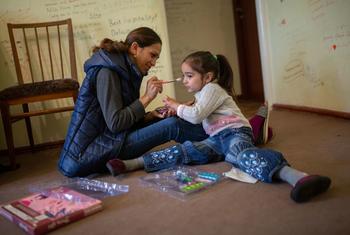 A mother plays with her daughter at home in Armenia.