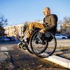 It takes Dmitry Kuzuk, an activist for persons with disabilities, a lot of skill and effort to navigate through city streets in his wheelchair.