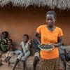 In Mazambara, Zimbabwe, where rain has been very sparse, a woman shows a plate of cicadas, one of the food options available after the WFP food ration is over.