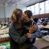 A refugee from Ukraine hugs her son in a reception centre set up in the sports hall of a school in the Polish border town of Medyka.