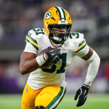 Emanuel Wilson #31 of the Green Bay Packers carries the ball during a game between the Minnesota Vikings and Green Bay Packers at U.S. Bank Stadium on December 29, 2024 in Minneapolis, Minnesota. 