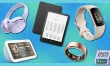 bose headphones, a kindle paperwhite, fitbit fitness tracker, and oura ring on a blue and turquoise background