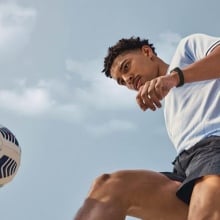 Person playing soccer and wearing Fitbit Charge 3