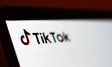 A zoomed-in photo of the TikTok homepage on a laptop screen.