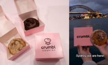 A composite of two images. On the left, three boxes of Crumbl Cookies, two of them open showing the cookies inside. On the right, a screenshot of a video from YouTube channel CrumblCookieAus, showing hands holding up a Crumbl Cookie and box in front of the Sydney Harbour Bridge. Text on the screenshot reads, "Sydney we are here!"