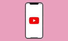 A phone screen with a YouTube logo on a pink background. 