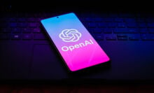 the OpenAI logo is displayed on a smartphone screen