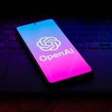 the OpenAI logo is displayed on a smartphone screen