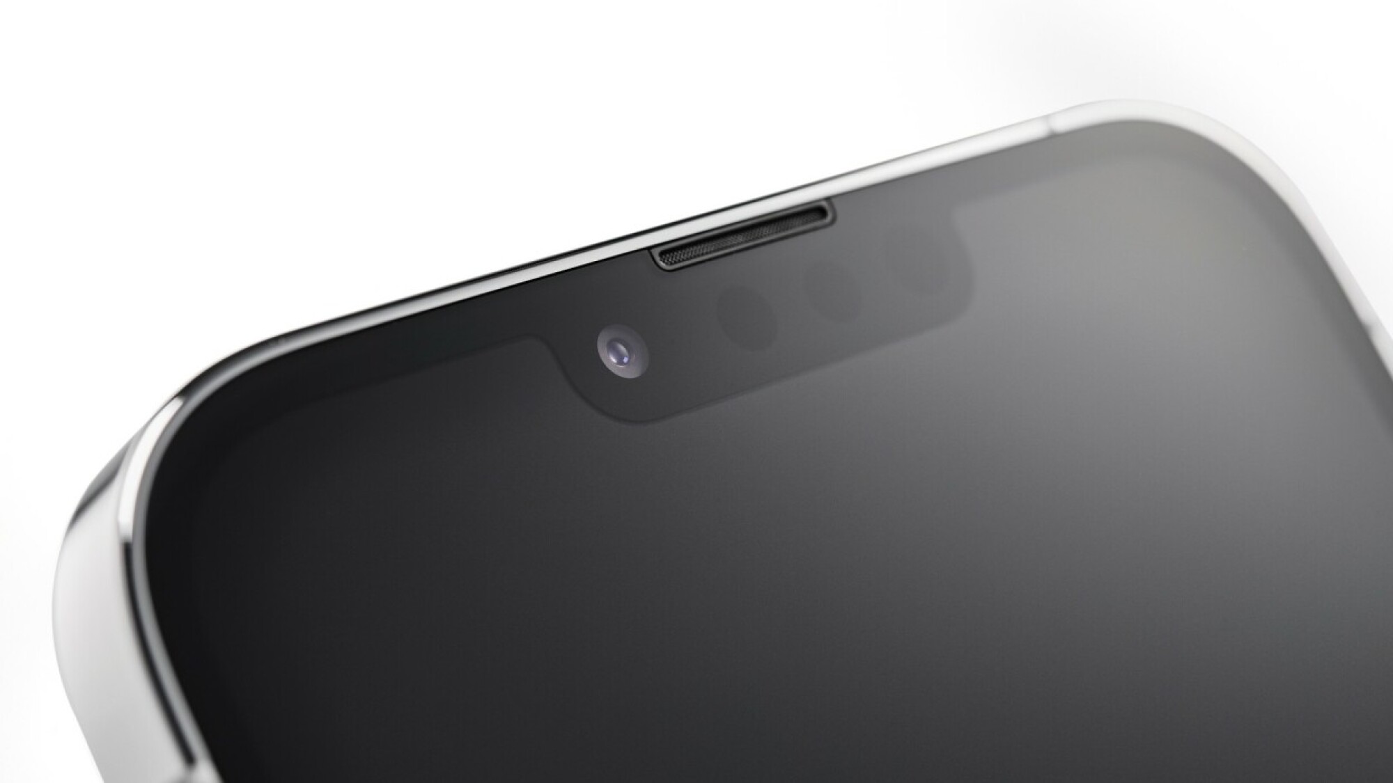 Close up of the top of an iPhone, showing the notch at the top of the screen and camera inside. 