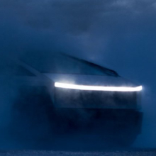 Tesla Cybertruck emerging from the dark.