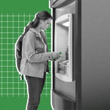 A woman has cash at an ATM machine. 