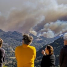 LA-area residents watch fires engulf the hills above Pacific Palisades.