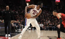  Joel Embiid #21 of the Philadelphia 76ers looks to pass away from Toumani Camara #33 of the Portland Trail Blazers during the third quarter at Moda Center on December 30, 2024 in Portland, Oregon. 